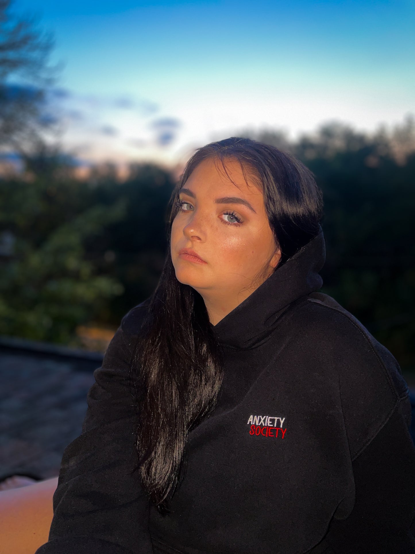 girl wearing anxiety society hoodie